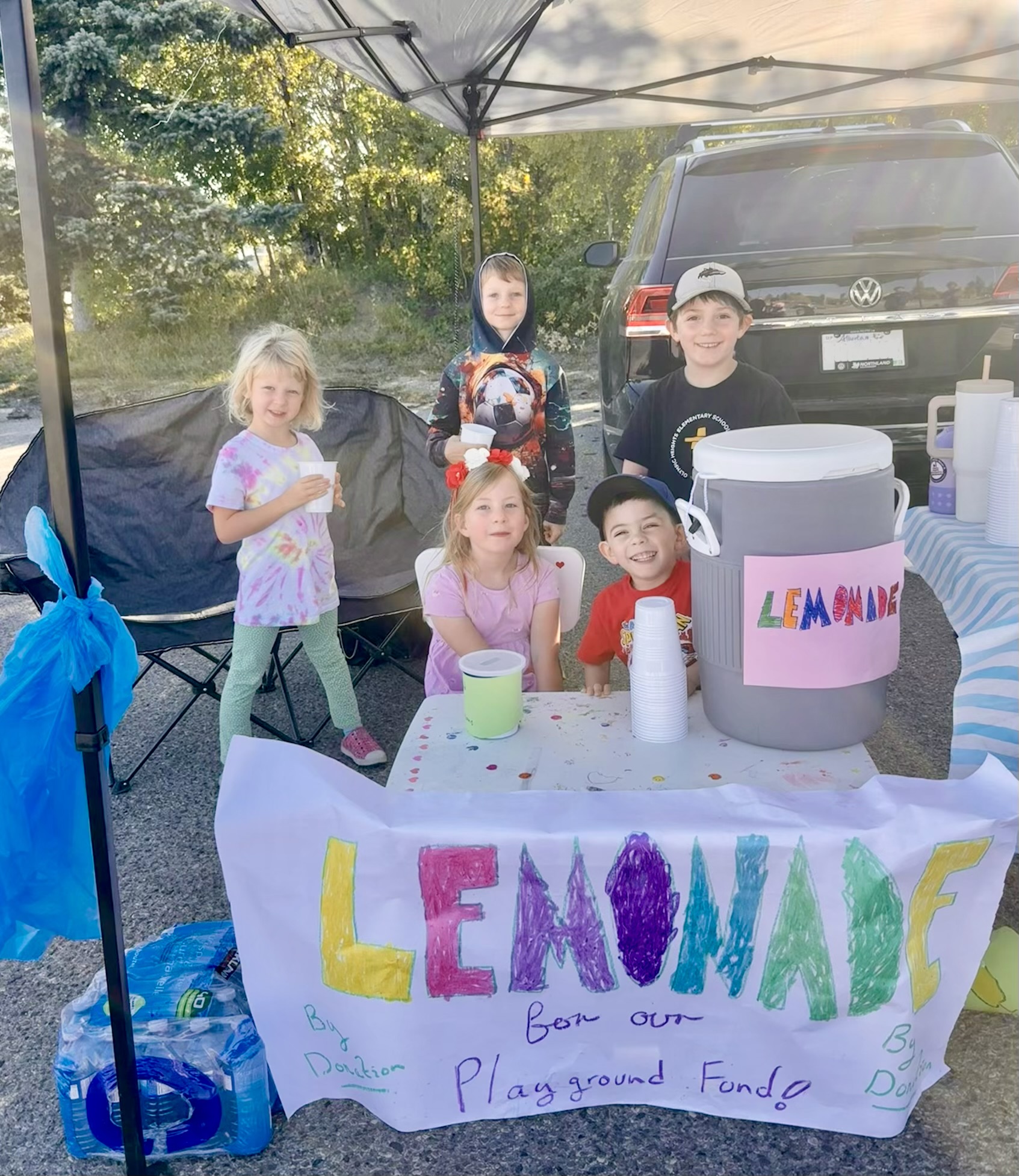 Four children selling lemonade